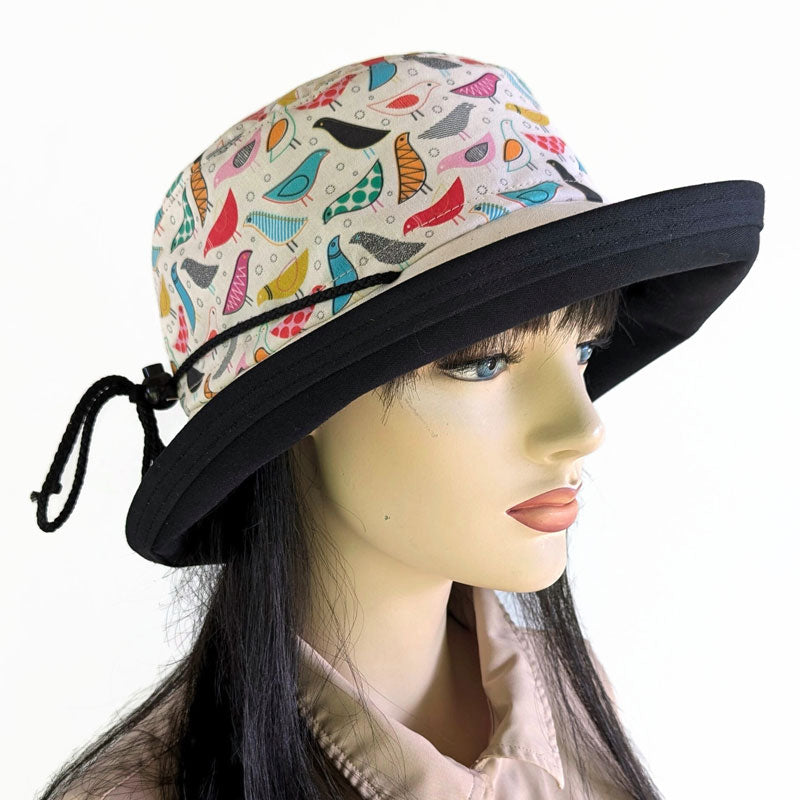 103-b UV Sunblocker with wide brim featuring artsy birds