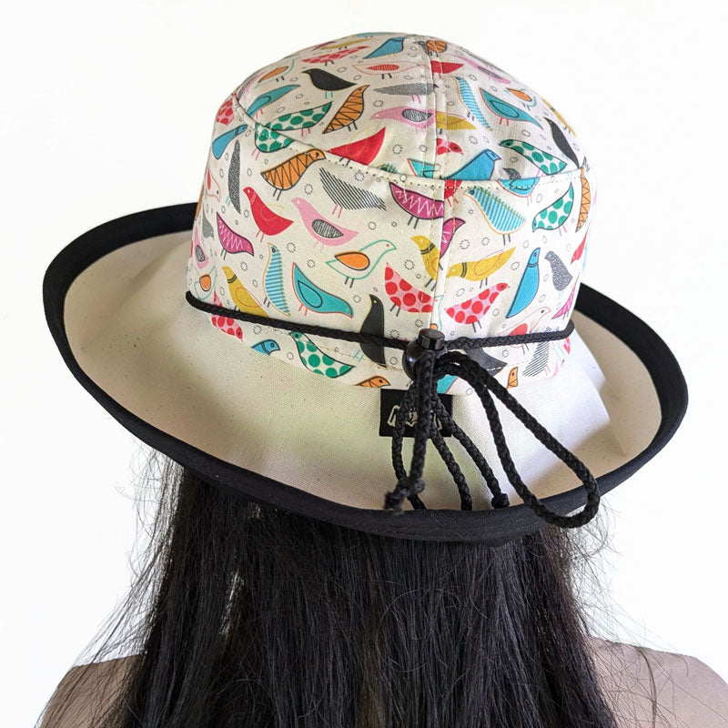 103-b UV Sunblocker with wide brim featuring artsy birds