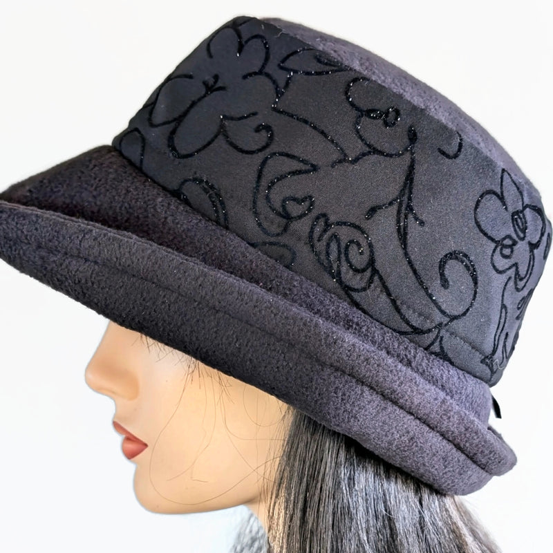 Niagara Fashion Bucket Hat with earflaps,  in black fleece with sparkly black abstract band and flattering brim