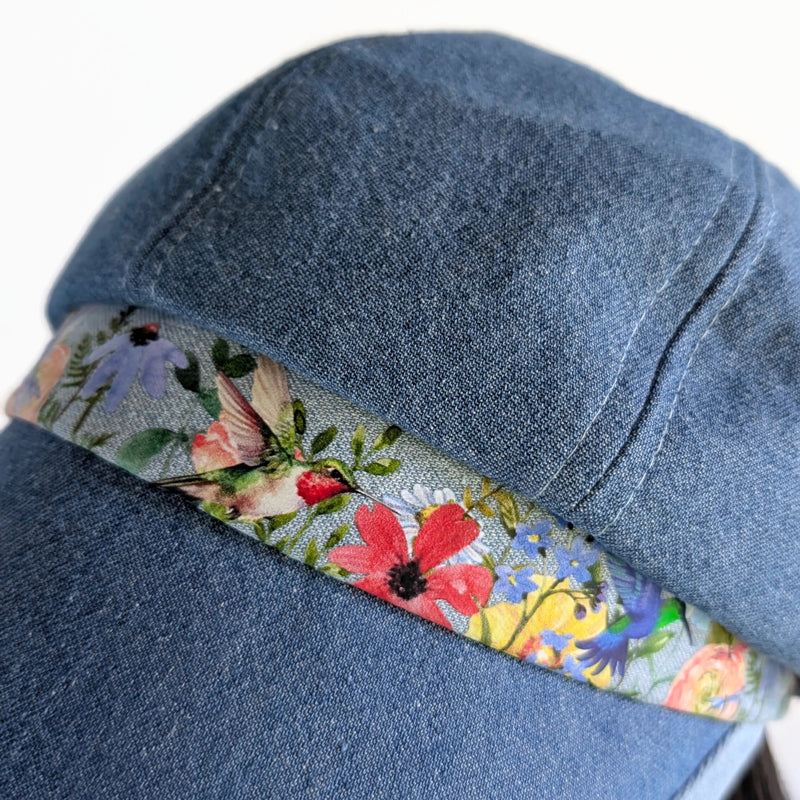 Poorboy Fashion Cap in washed blue denim, floral with hummingbird accents, flattering visor, baggy fit