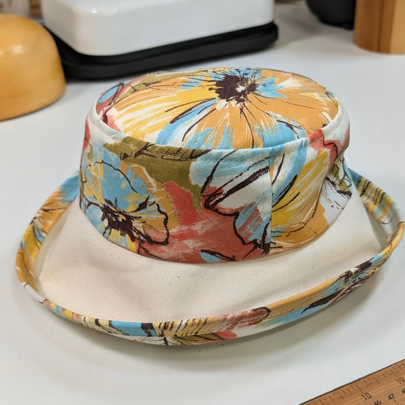 Weatherblocker rain/sun  fun hat built to resist sun, rain and stains, orange and earth tone floral