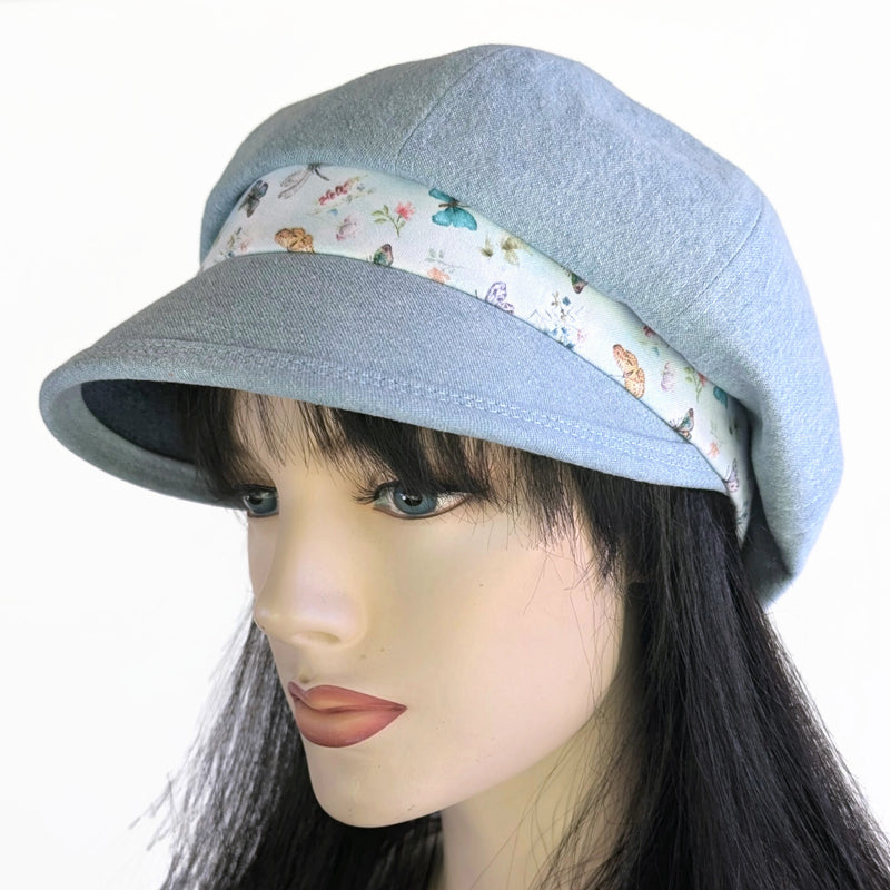 Poorboy Fashion Cap in bleached blue denim, pale butterfly dragonfly accents, flattering visor, baggy fit