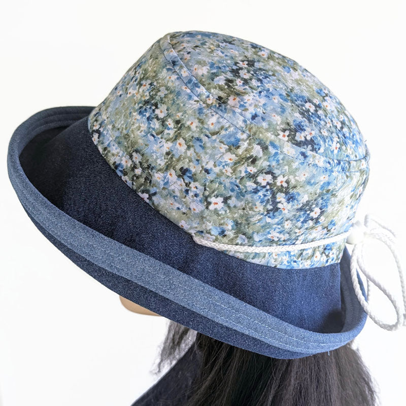 Sunblocker UV summer sun hat with wide brim, blue daisy print, adjustable fit