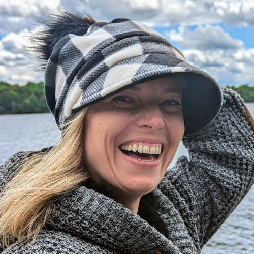 Fashion Pom Pom Cap in fleece with flattering visor and slouchy fit, assorted plaids