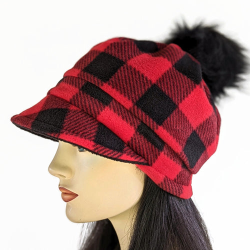 Fashion Pom Pom Cap in fleece with flattering visor and slouchy fit, assorted plaids